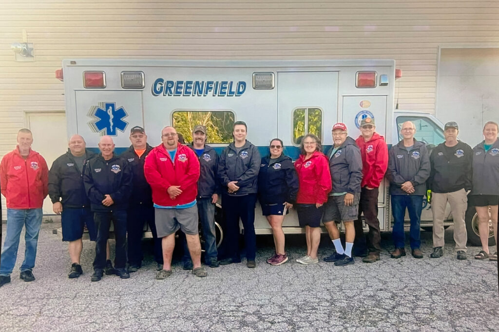 people standing in front of ambulance