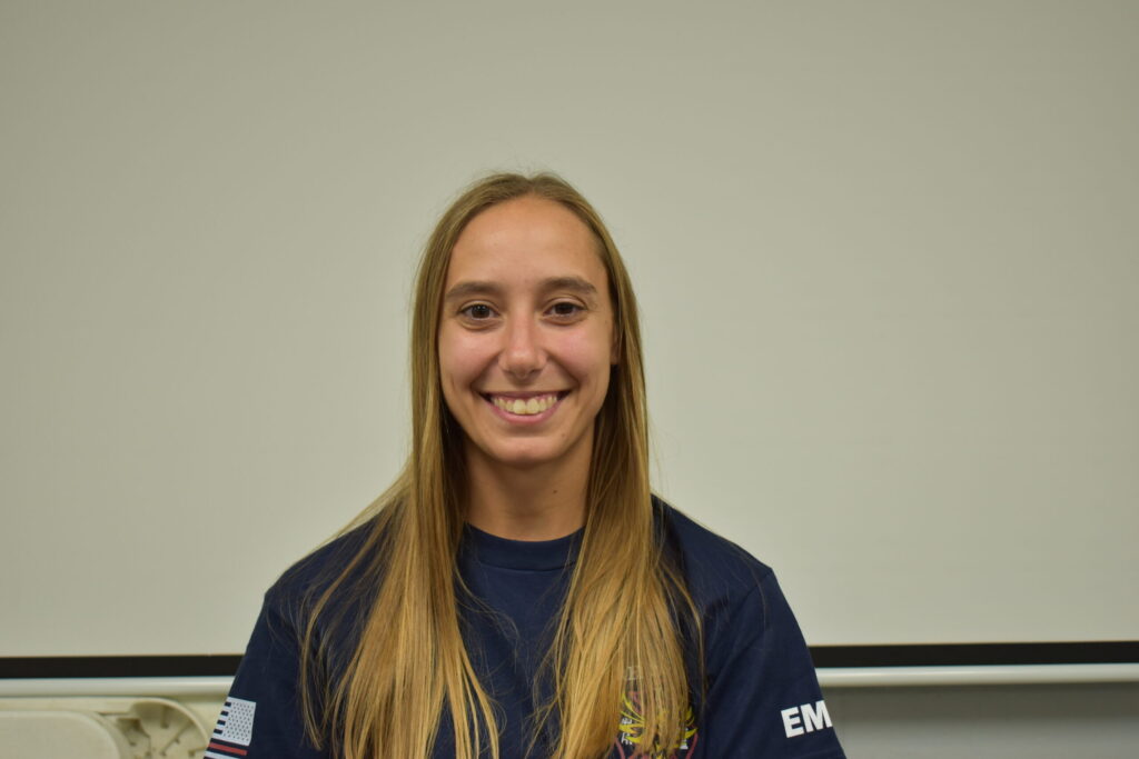 a woman with a blue shirt on and long hair
